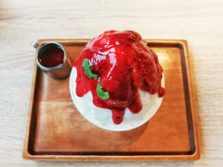 Ice milk Korean dessert, Bingsu with strawberry and sauce. Top view.の写真素材