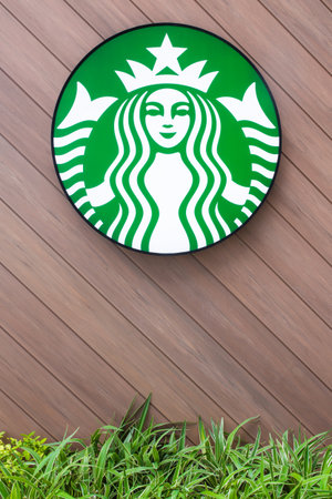 Bangkok, Thailand - July 9, 2017: Starbucks coffee Logo brand on a diagonal wooden wall panel with...