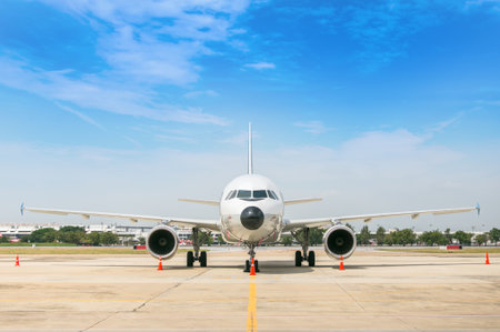 Airport building and airplane on runway.のeditorial素材