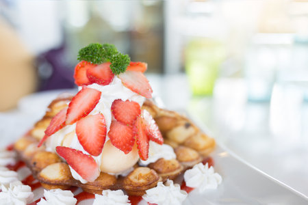 Strawberry Hong Kong waffle or bubble waffle with vanilla ice cream and wip cream.の写真素材