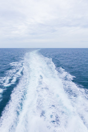 Sea background image with white foamy wave.の写真素材