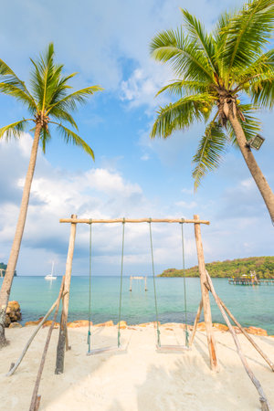 Wooden swing and coconut palm tree over summer beach sea in Ko Kut or Koh Kood, Trat Province,Thailand. Summer, Travel, Vacation and Holiday conceptの写真素材