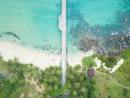 Aerial view of beautiful tropical resort beach with wooden pier into the sea.
