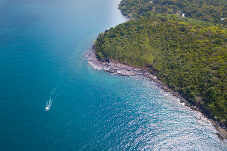 Aerial view of speed boat in sea. Speed boat at sea, view from above. Speedboat floating in a turquoise blue sea water. Motorboat crossing ocean. Tropical landscape. Thailand.の写真素材