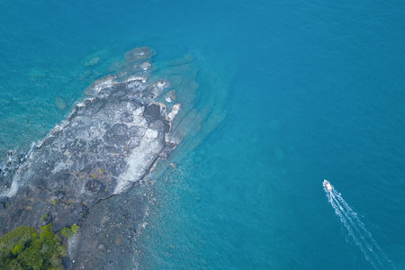 Aerial view of speed boat in sea. Speed boat at sea, view from above. Speedboat floating in a turquoise blue sea water. Motorboat crossing ocean. Tropical landscape. Thailand.の写真素材