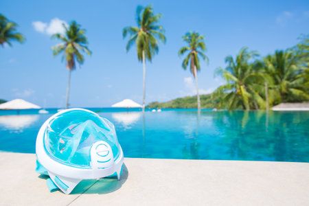 Goggles or mask for snorkeling or swimming near the pool at sunny day. selective focus shot.の写真素材