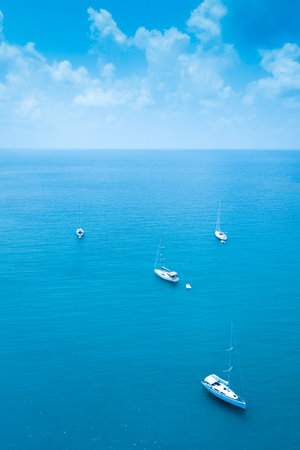 Aerial view of Sailing. Ship yachts with white sails in the Sea. Luxury boats. Boat competitor of sailing regatta.の写真素材
