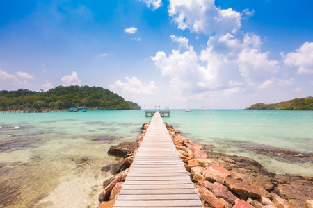 Wooden bridge pier into the beautiful beach background.の写真素材