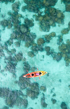 Aerial view of Couple canoeing or kayaking at sea island backdrop. Lipe Island, Thailand. Space for textの写真素材