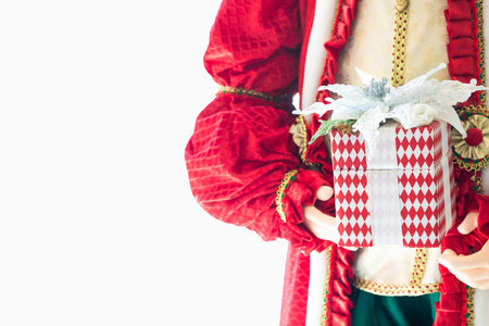 Santa Claus with Christmas gifts. Happy Santa Claus is holding gift boxes isolated on white background. Santa Claus carries gifts to children.の写真素材