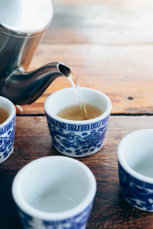 Chinese hot tea. Hot Tea being poured into a tea cups.の写真素材