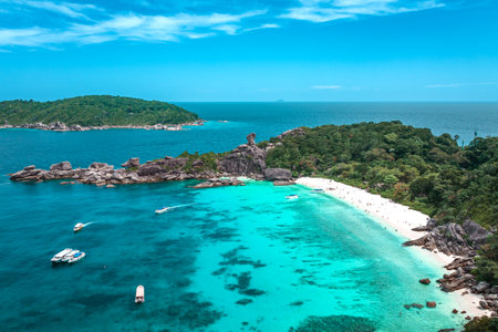 Aerial view over one of Similan island and it's shape look like heart in sea with green tree forest and blue or turquoise color in Thailand.の写真素材