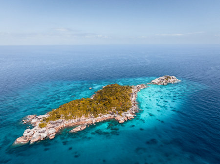 Aerial view over one of Similan island and it's shape look like heart in sea with green tree forest and blue or turquoise color in Thailand.の写真素材