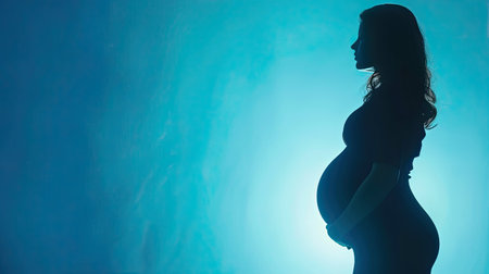 Beautiful pregnant woman standing on blue background. Ai generated..の素材