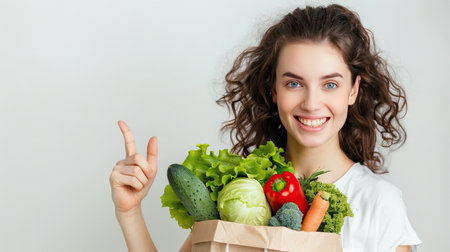 Young woman is holding healthy groceries in paper bag from supermarket pointing and showing with thumb up to the side with happy face smiling on isolated white background. AI Generated.の素材
