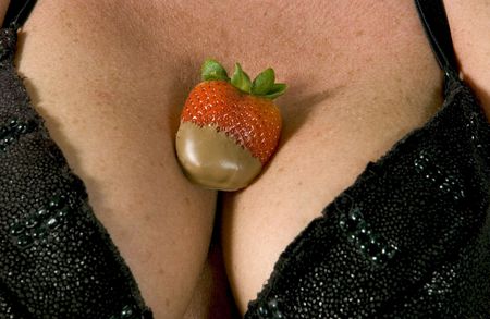 Chocolate covered strawberry in cleavageの写真素材