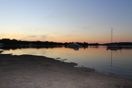 Sunrise by the waterの写真素材