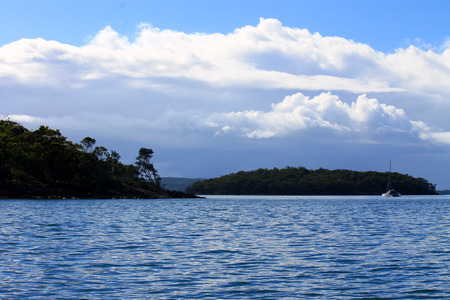Island seaside or ocean landscape, travel image of boats, blue sky, clouds and water. Cliffs and ocean landscape.の写真素材