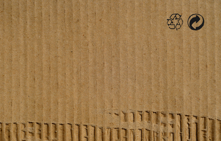 Cardboard brown paper texture background with recycling signsの写真素材