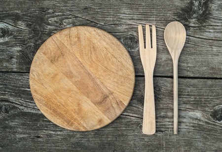 Cutting board on rustic wooden background. Top viewの写真素材