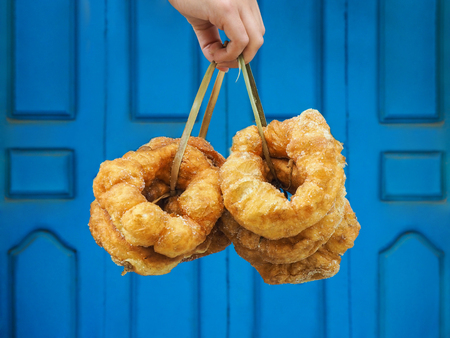 Hand holding traditional fresh baked donuts in Moroccoの写真素材