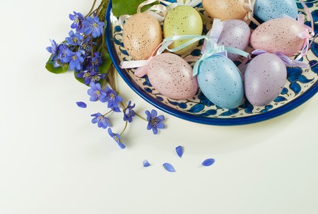 Colored eggs with violets on white background. Easter, Spring holidaysの写真素材