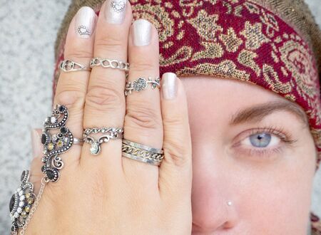 Close-up of a womans hands with many beautiful rings