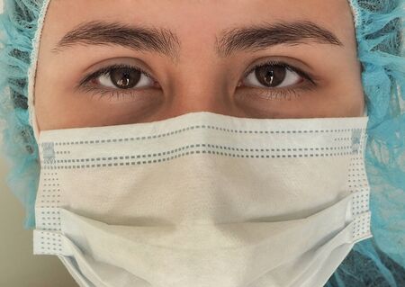 Nurse wearing protection face mask against coronavirusの写真素材