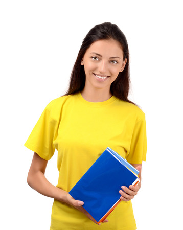Beautiful student in yellow blouse holding books. Isolated on white.の写真素材