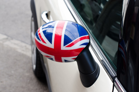 Close up on a side mirror of a car with the UK flag on it. Patriotic driver. England flag.の写真素材