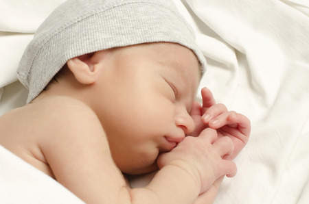 New born baby boy sleeping. Little baby with cute gray hat taking a nap.の写真素材