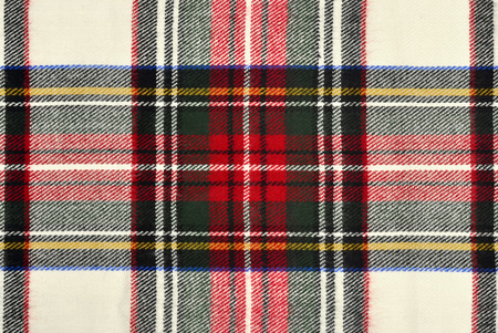 Scottish tartan pattern. Red and white wool plaid print as background. Symmetric square pattern.