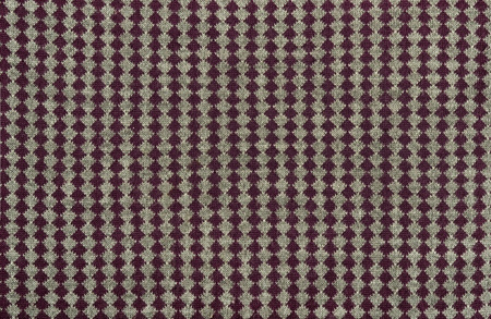 Close up on knit woolen texture. Purple line of rhombus on grey fabric as a background.