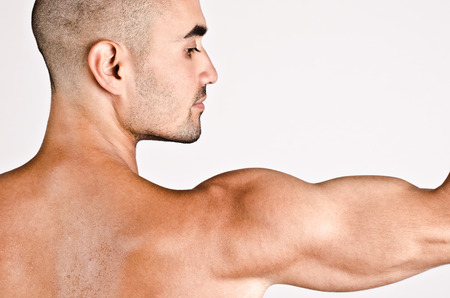 Close up on profile of a man and the arm with the shoulder and biceps.の写真素材