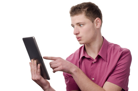 Young man pointing to a tablet Isolated on white.の写真素材
