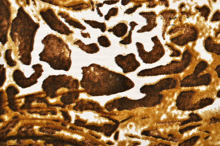 Brown leopard fur pattern. Spotted animal print as background.