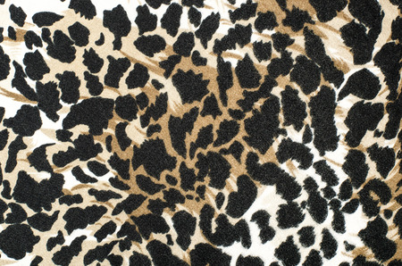 Brown and black leopard fur pattern. Spotted animal print as background.の写真素材
