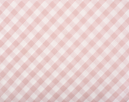 Close up on checkered tablecloth fabric. Pink with white tartan square pattern as background.の写真素材
