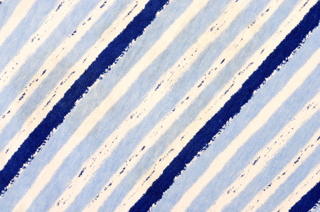 Navy blue striped background. Blue and white diagonal stripes pattern on fabric.の写真素材