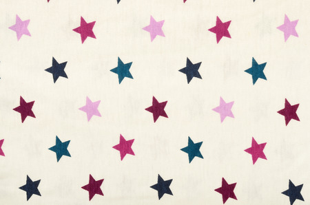 Pink five-pointed stars on white fabric. Purple, pink and blue stars as a background.の写真素材
