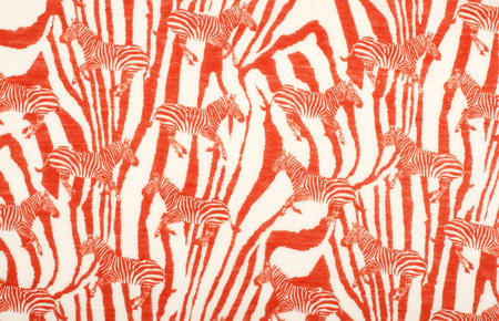 Orange and white zebras on striped zebra background. Animal print pattern on fabric.の写真素材