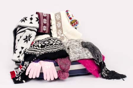 Winter luggage. Suitcase full of wither clothes.の写真素材