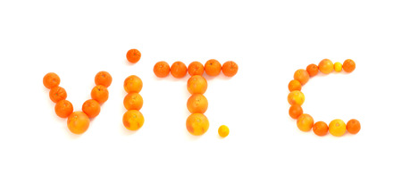 Vitamin C written on white background with citrus fruits. Oranges, grapefruits and lemons making a vitamin text.の写真素材
