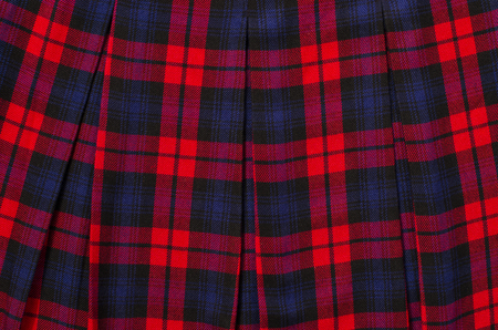 Scottish tartan pattern. Red plaid print as background. Colored lines and square pattern. Scottish...