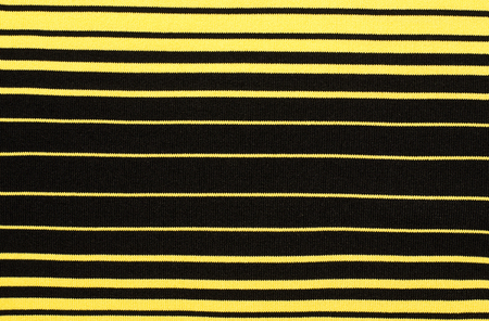 Striped black and yellow textile pattern as a background. Close up on horizontal stripes material texture fabric.の写真素材