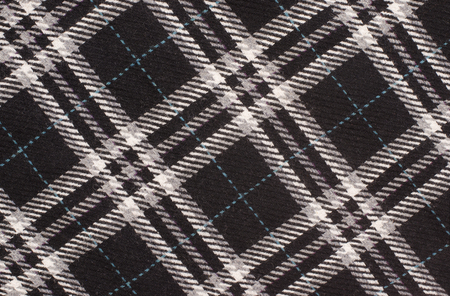 Tartan pattern. Black and white with blue plaid print as background. Asymmetric square pattern.