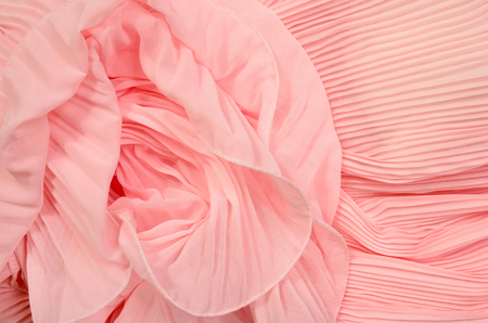 Close up on pink pleated lace. Pastel pink crumpled tulle as background.の写真素材