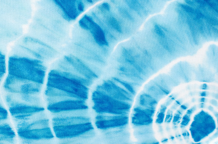 Abstract blue round shapes pattern on fabric. Blue with white lines circle shapes pattern on material as background. Water like print on fabric.の写真素材