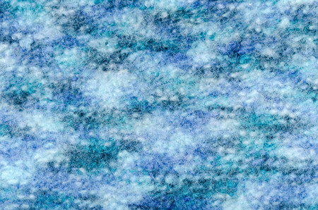 Close up on knit woolen fabric  texture. Blue woven fuzzy sweater as a background.