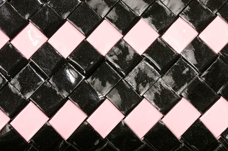 Close up on shiny plastic texture. Black and pink woven squared surface as a background.の写真素材